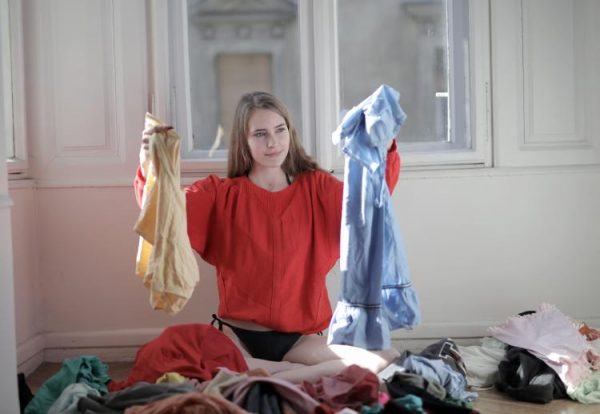 a woman trying to decide which clothes to wear